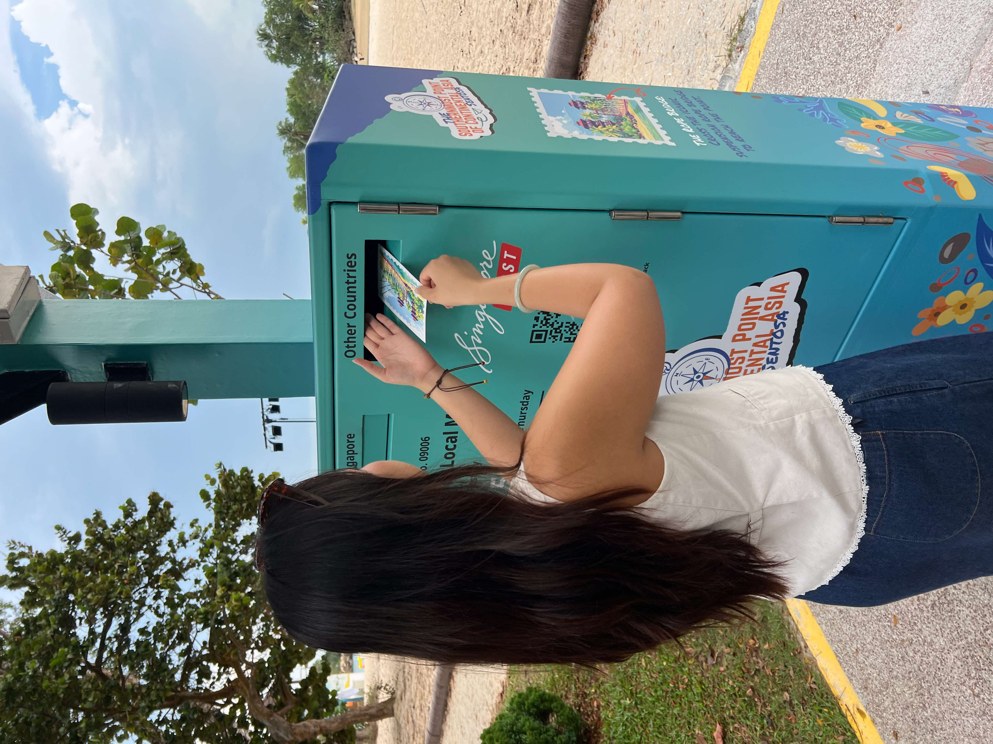 Woman sending in a postcard for delivery